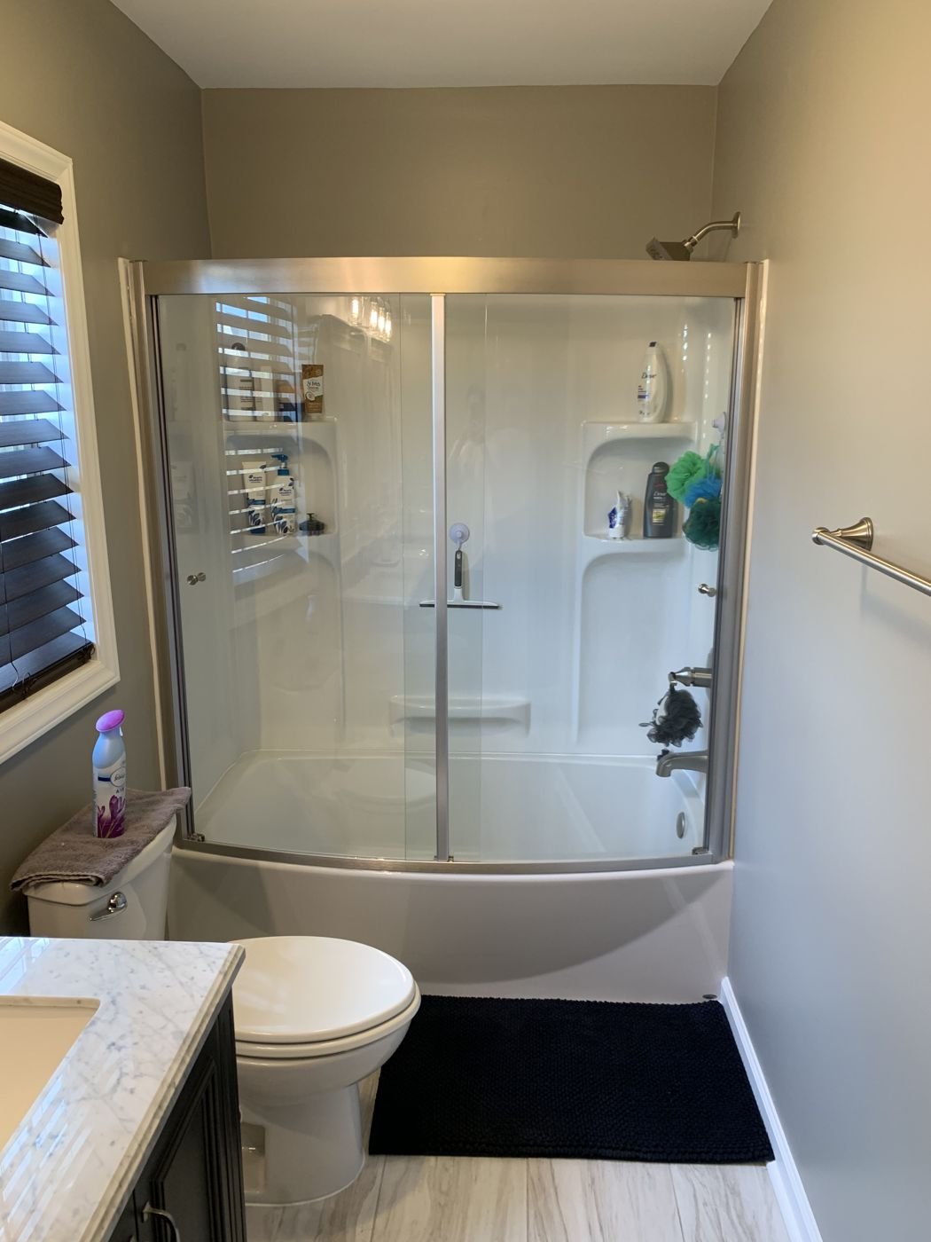 Tub and shower combo with a sliding glass door and marble-top vanity — Triangle Home Handyman, Apex NC