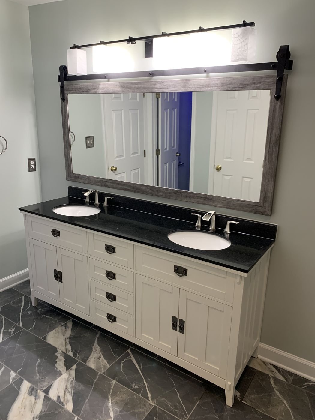 Double vanity with a black top and a rustic barn-style mirror — Triangle Home Handyman, Apex NC