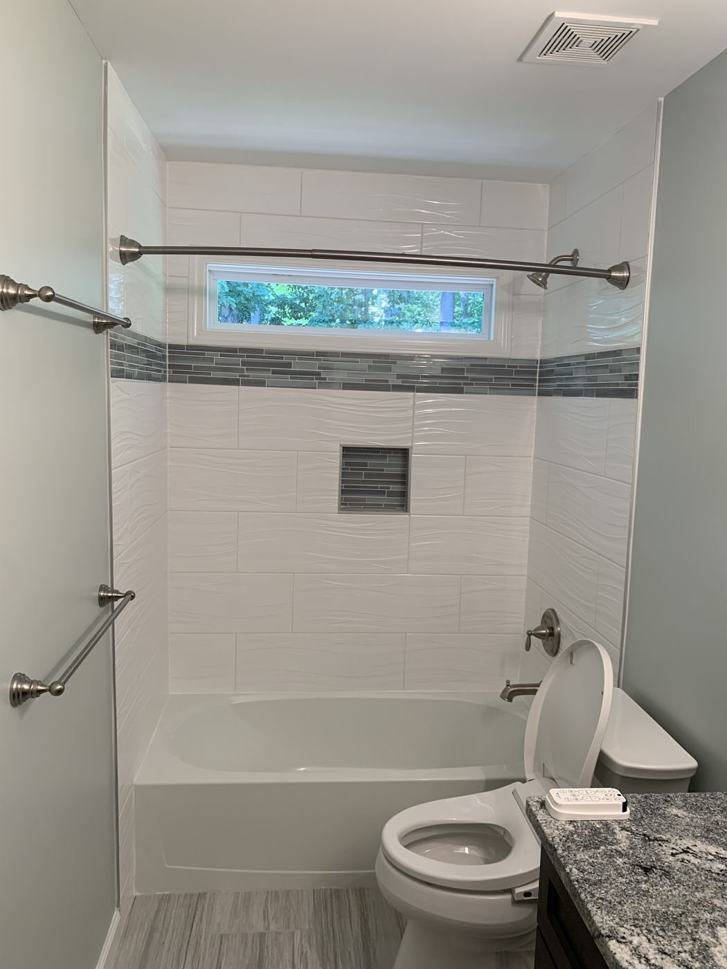 Bathtub surround with white subway tile and a mosaic accent stripe — Triangle Home Handyman, Apex NC