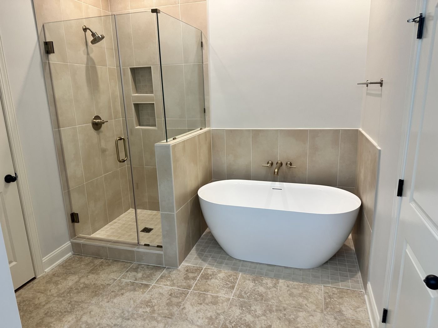 Corner glass shower with beige tile and a freestanding tub — Triangle Home Handyman, Apex NC