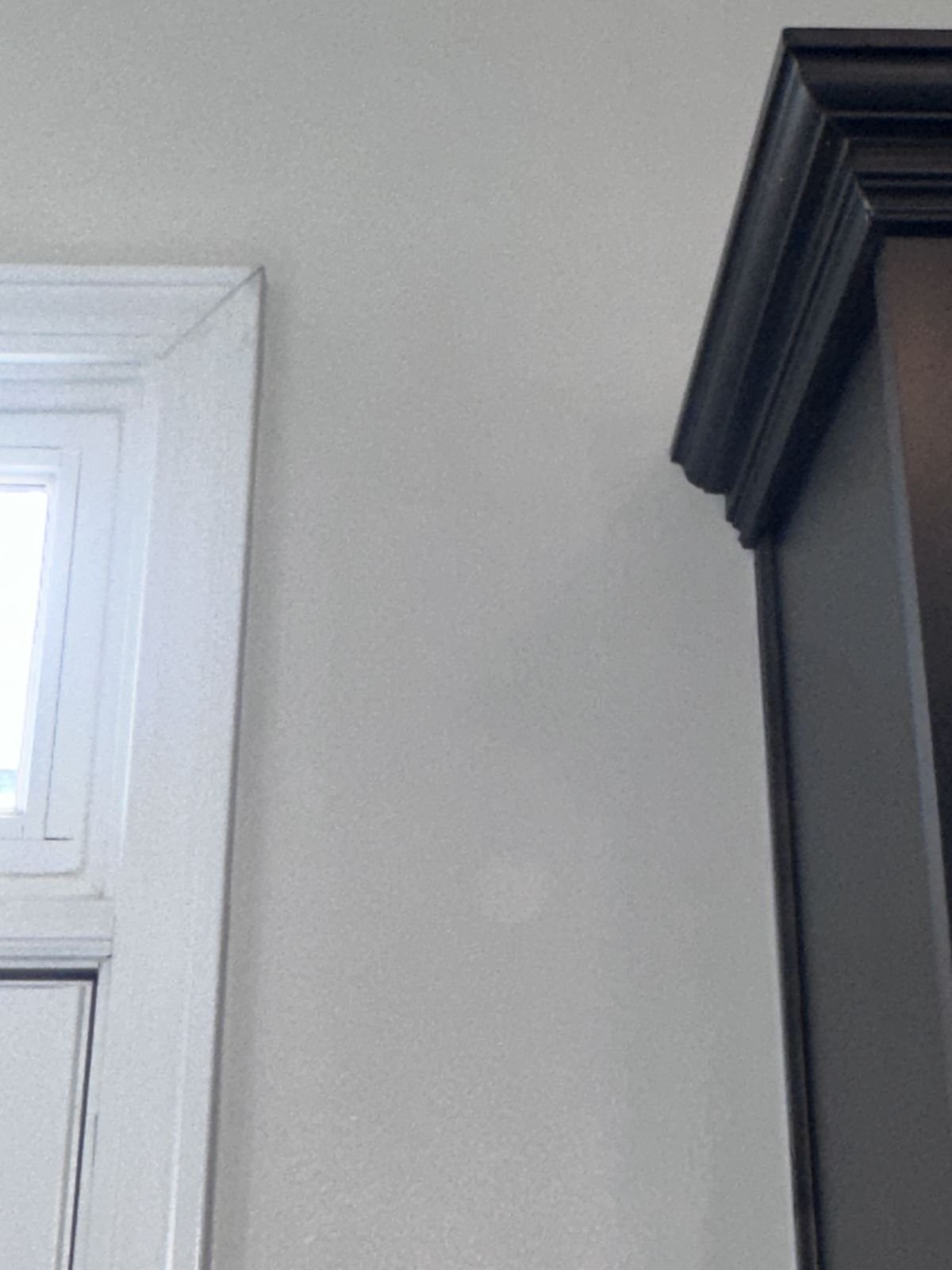 Smooth, painted wall corner beside a kitchen window after drywall repair — Triangle Home Handyman, Apex NC