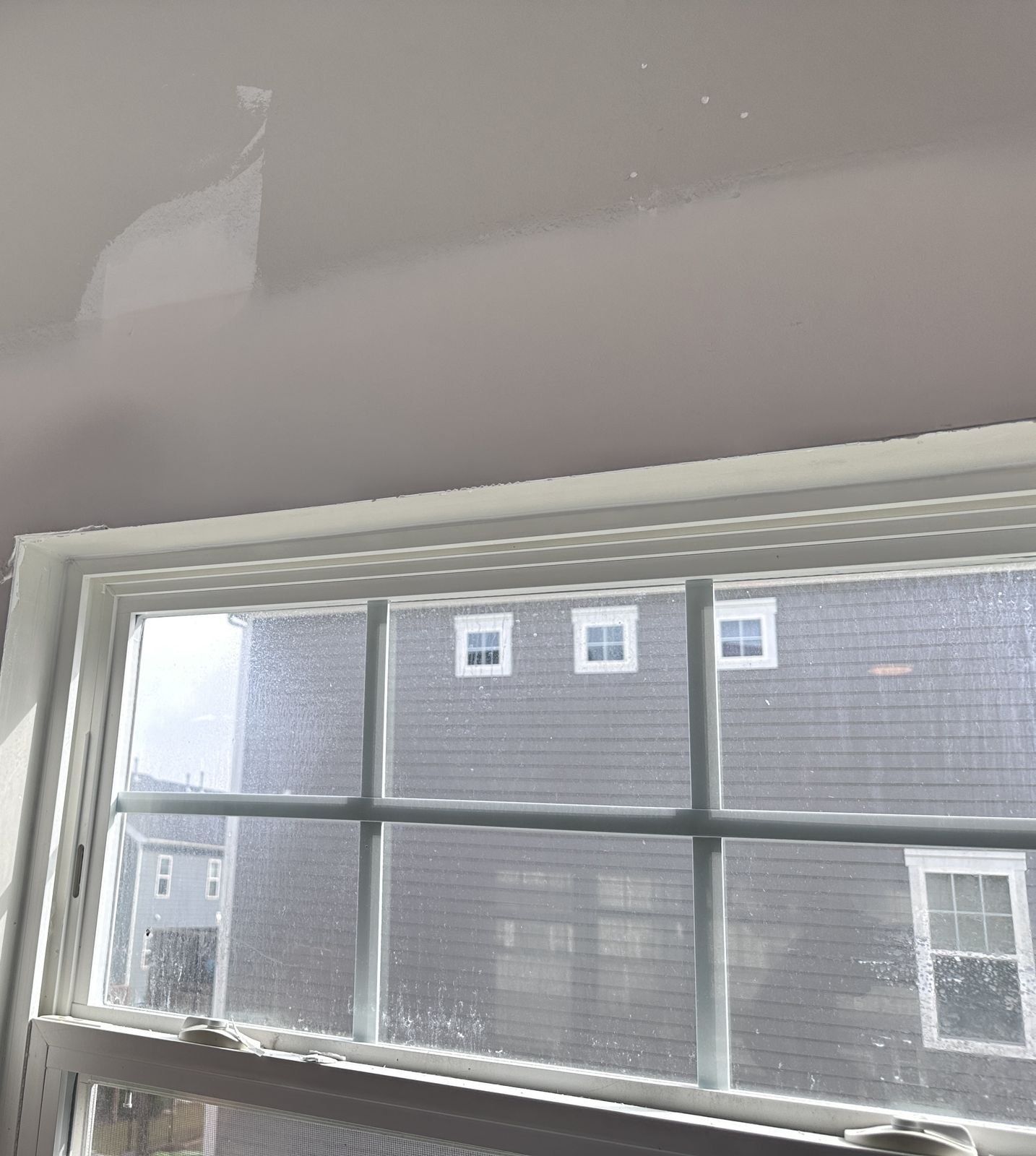 Patched and primed drywall above a kitchen window during the repair — Triangle Home Handyman, Apex NC