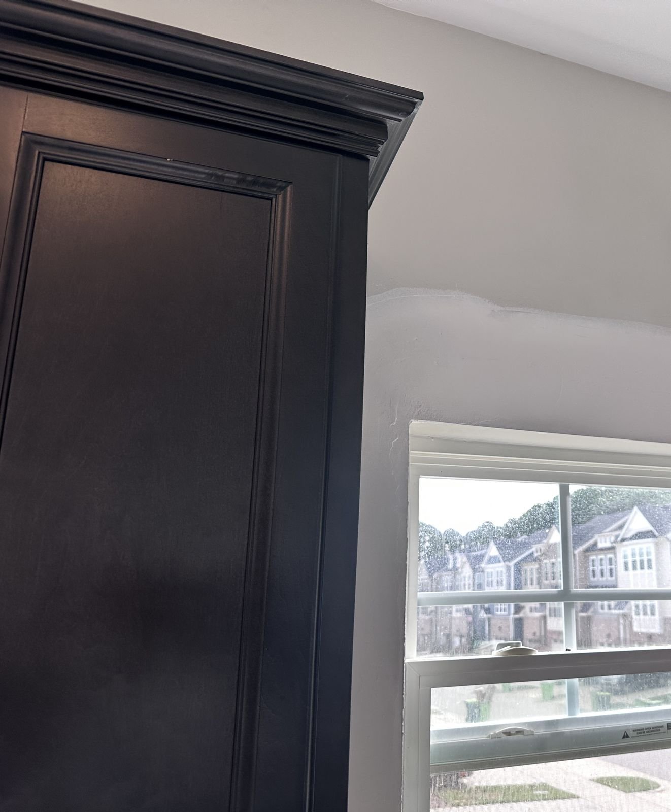 Drywall patch beside a kitchen cabinet during the repair — Triangle Home Handyman, Apex NC