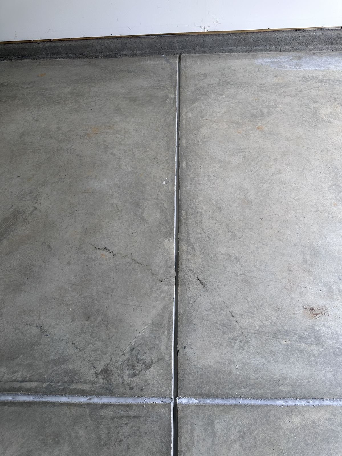 Garage floor crack filled with sealer, running along the slab joint — Triangle Home Handyman, Apex NC
