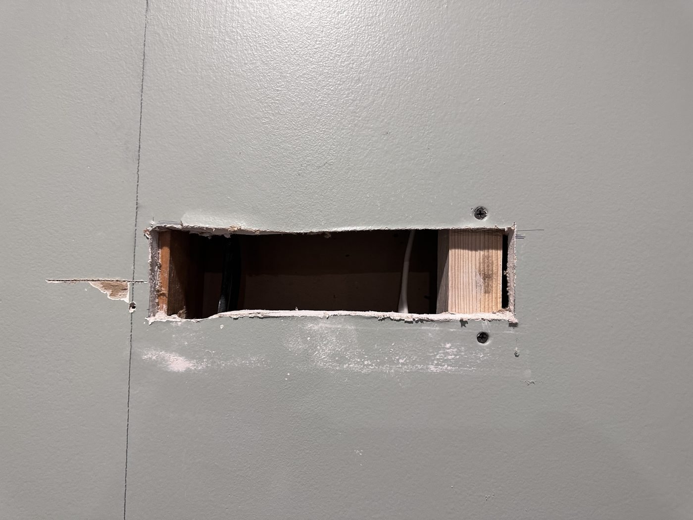 Outlet cutout exposed after cabinet removal