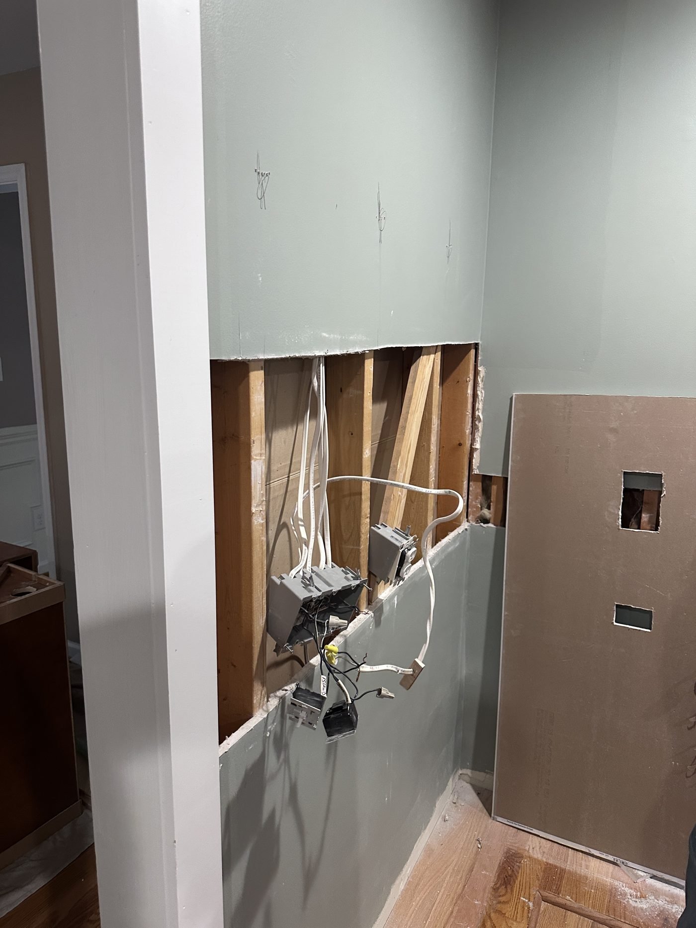 Exposed studs and wiring after cabinet removal