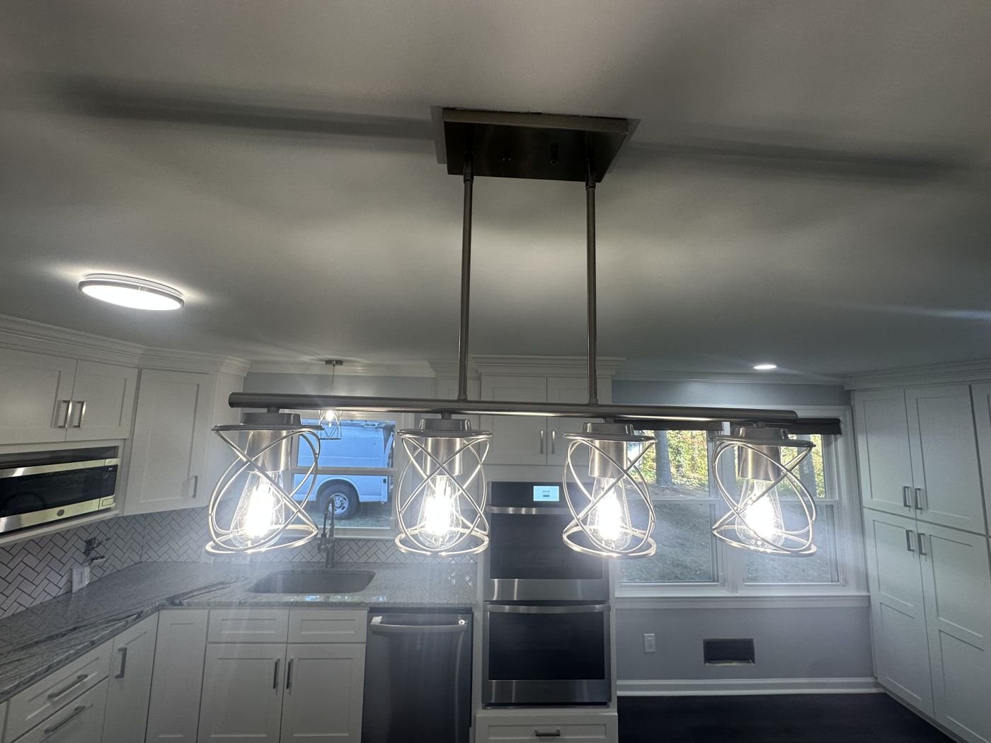 Cage-style pendant lights over a kitchen island — Triangle Home Handyman, Apex NC