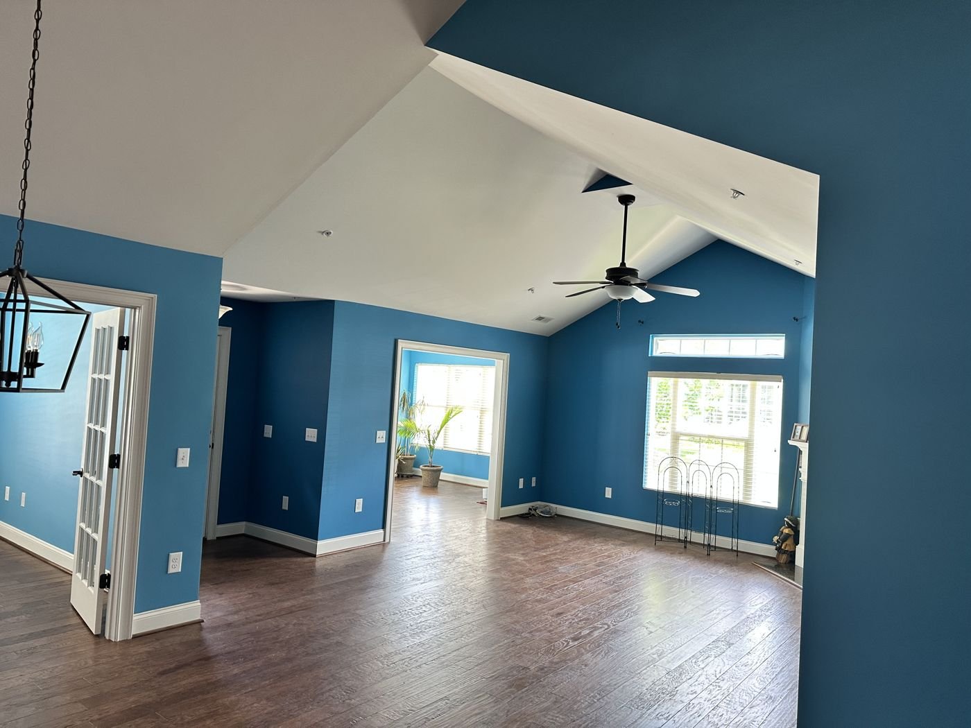 Vaulted living room with a ceiling fan and lantern pendant — Triangle Home Handyman, Apex NC