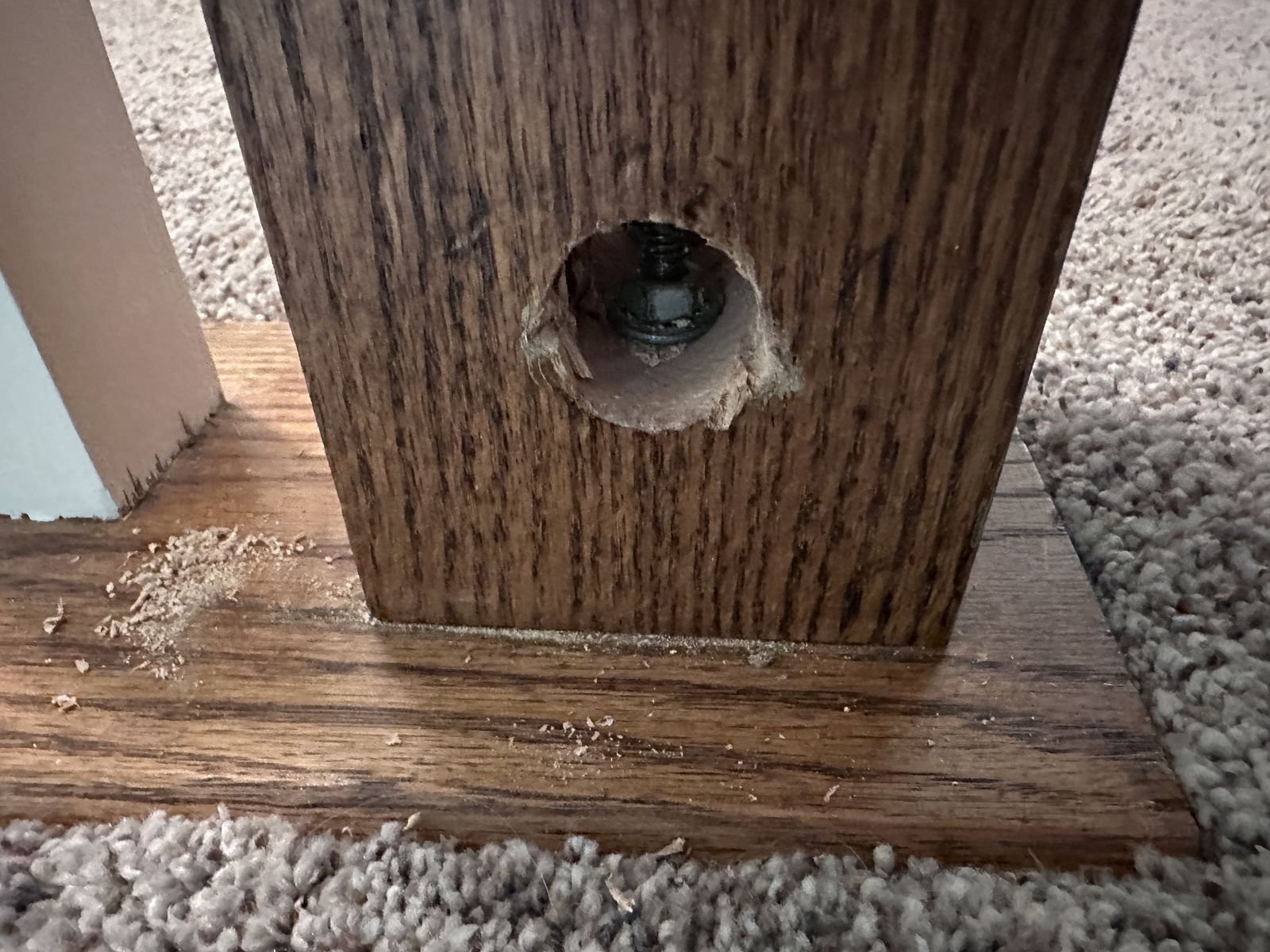 Mounting bolt visible inside the hole at the base of a newel post